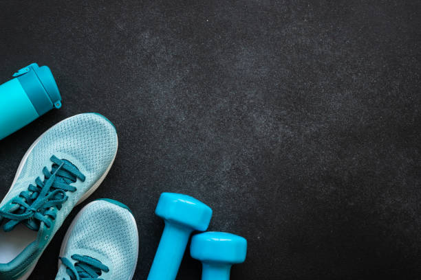 istock Fitness equipment at black background top view. 1637901368