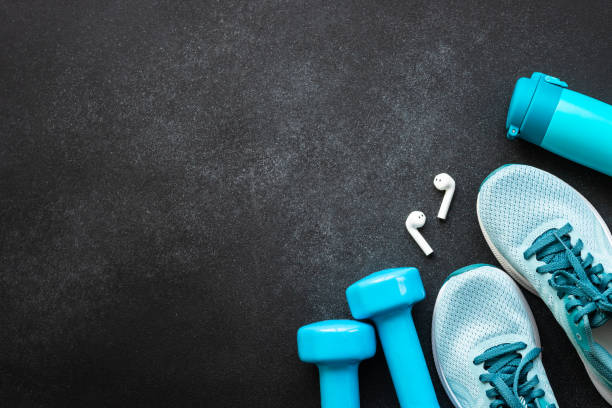 istock Fitness equipment at black background top view. 1637901369