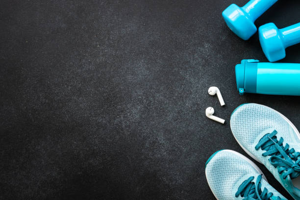 Fitness equipment at black background top view.