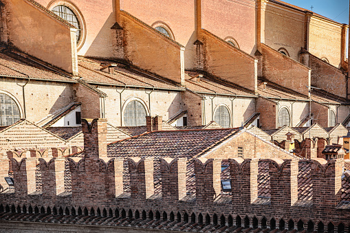 Detail of monumental complex made of brick surrounded by brick wall in Bologna, Italy