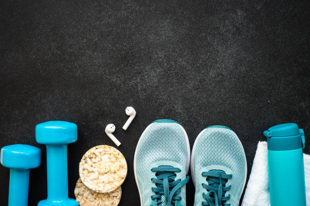 istock Fitness equipment at black background top view. 1637902417