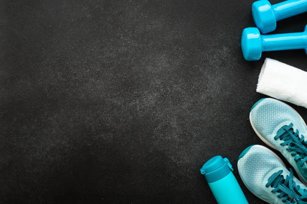 istock Fitness equipment at black background top view. 1637902943
