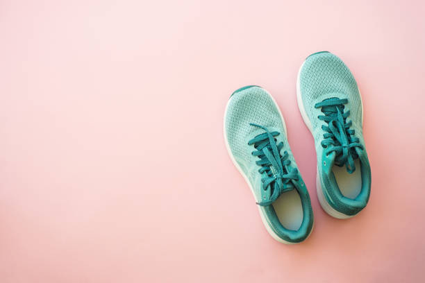 istock Sneakers at pink background top view. 1637903481