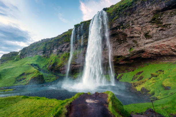 istock Seljalandsfoss waterfall flowing and lush mountain in summer at Iceland. 1637920361