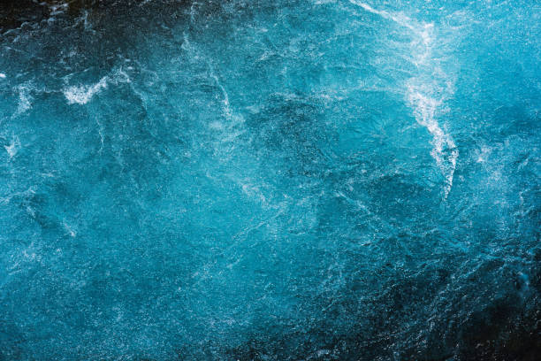 istock Crystal blue water with air bubbles flowing motion 1637920611