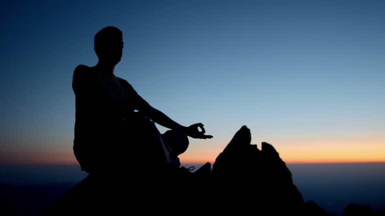 HD DOLLY: Silhouette Of A Man Meditating