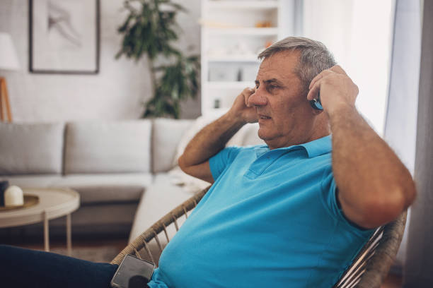 istock A mature man is using headphones and a mobile phone 1637956326
