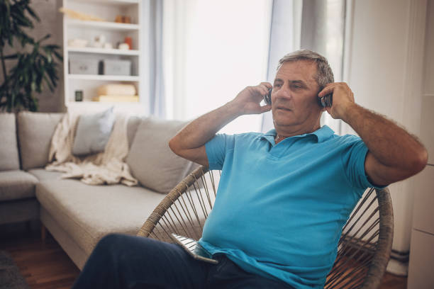 istock A mature man is using headphones and a mobile phone 1637956623