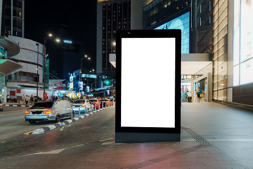 A sizable blank billboard, nestled in the city's heart, awaits your text or content, offering ample space to convey your message to a wide audience.