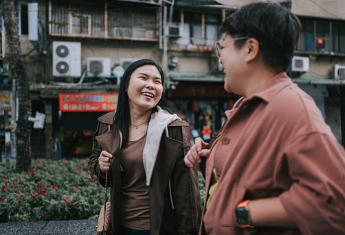 2 Asian Chinese female tourist walking at Taipei Old Town District