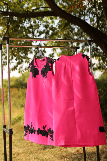 istock A red dress with a bow on a hanger. 1637994585