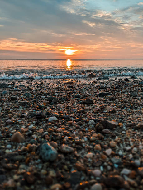 istock Sunrise on the pebbles of a Cape Cod beach 1638021827