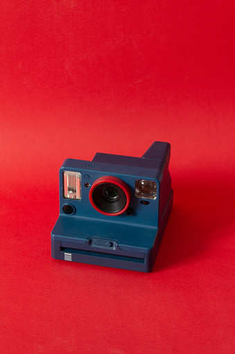 Vintage 35mm rangefinder film camera isolated on yellow / orange colored background