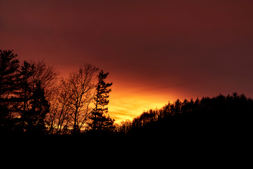 a dramatic sunset on the hills of new hartford connecticut.