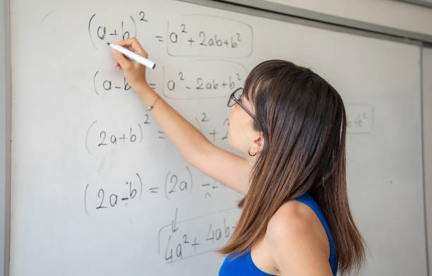 istock A teacher at school teaches by writing on a white erasable blackboard 1638038378