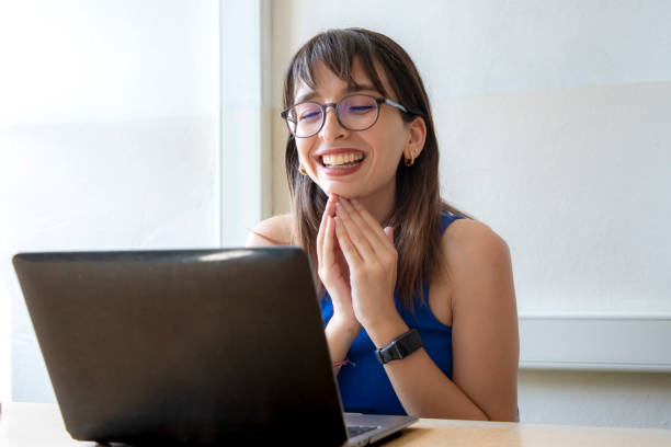 istock A teacher working with her computer at the desk in the classroom at school 1638049289