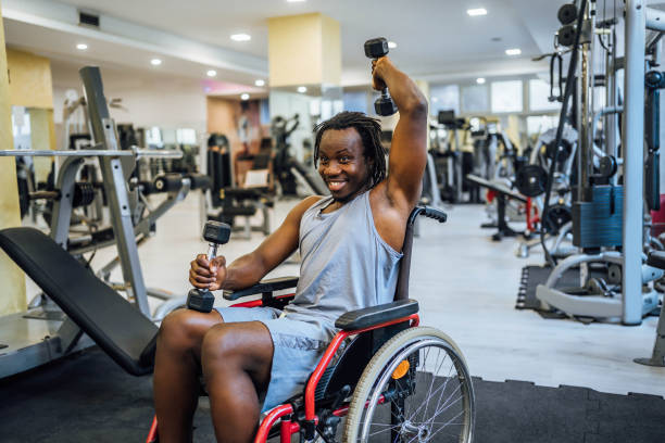 istock Disabled man exercising with weights in a gym 1638052603