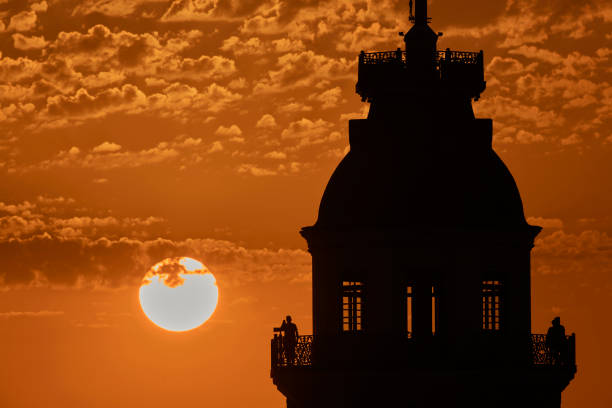 one of a series photos which different phases of sunset movement with silhouette people moving and changing in background