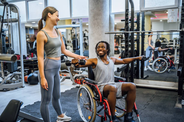 istock Disabled young man having exercise class with a fitness instructor 1638068188