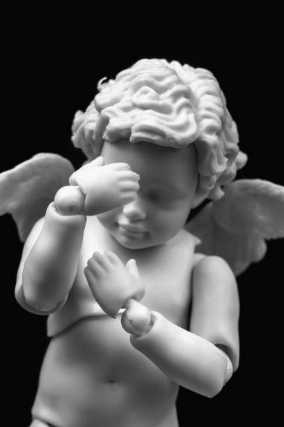 figurine of an angel Cupid with a bow on a pink background. Valentine's Day. High quality photo