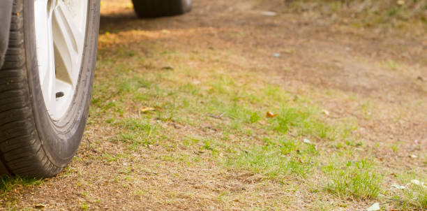 istock Car tire close up,parked car low angle shot 1638088262