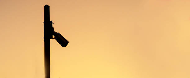 istock Silhouette of security camera on sunset,banner 1638088267
