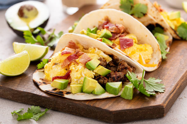 istock Breakfast tacos with sausage, eggs, bacon and avocado 1638098344