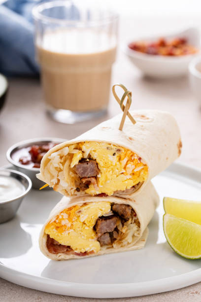 istock Breakfast burritos with scrambled eggs, sausage, cheese and potatoes 1638098601
