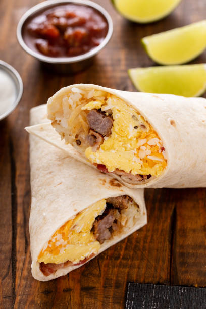 istock Breakfast burritos with scrambled eggs, sausage, cheese and potatoes 1638098610