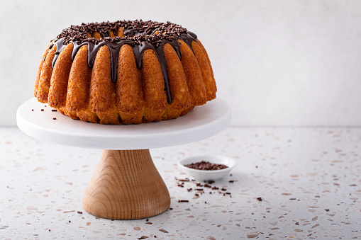 Orange pound bundt cake with dark chocolate ganache and chocolate sprinkles