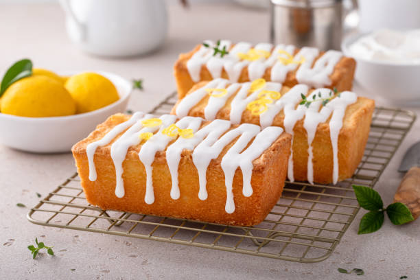 istock Classic lemon pound cake with powdered sugar glaze dripping over 1638099196