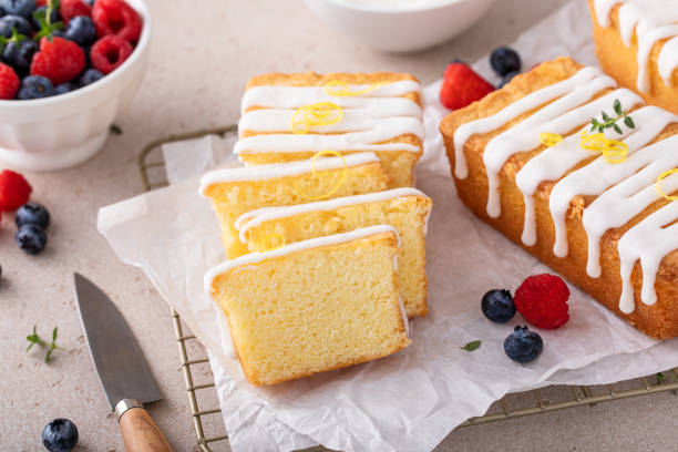 istock Classic vanilla pound cake with powdered sugar glaze sliced on parchment 1638099222