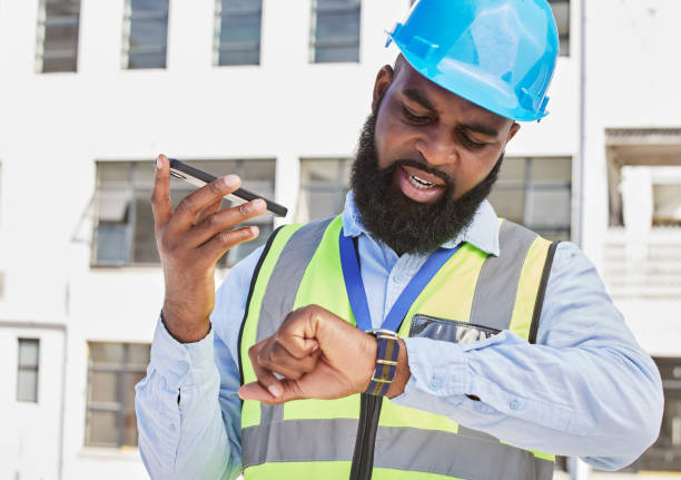 istock Watch, man or architect on a phone call or construction site speaking of building time schedule or project. Voice speaker, talking or African designer in communication or discussion about engineering 1638102604