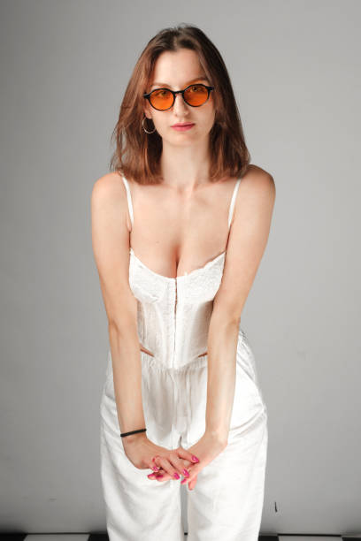 istock Sensual beautiful young woman posing in white top 1638107618