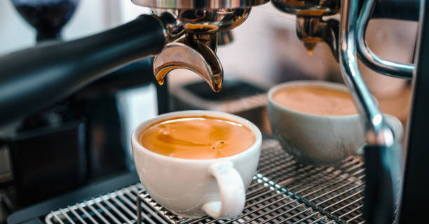 istock Coffee extraction from the coffee machine with a portafilter pouring coffee into a cup,Espresso pouring from the coffee machine at coffee shop 1638110335