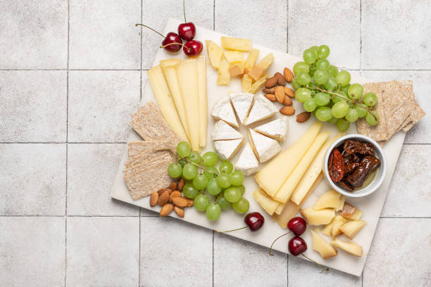 istock Farm cheese sliced with grapes, cherries and sun dried tomatoes 1638114225