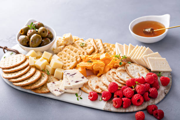 istock Cheese board or snack board with crackers, cheese, olives and berries 1638114986