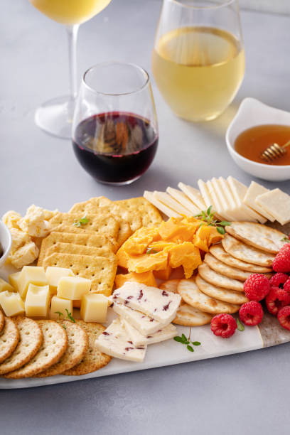 istock Cheese board or snack board with crackers, cheese, olives and berries 1638115503