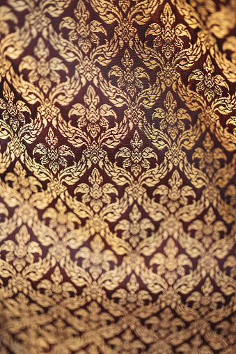 Backgrounds of Thailand style fabric pattern with golden