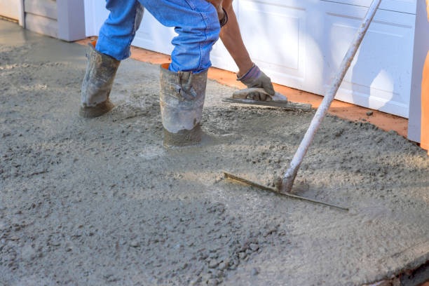 istock Concrete leveling workers on construction site with a mix trowel leveling to concrete driveway 1638124335