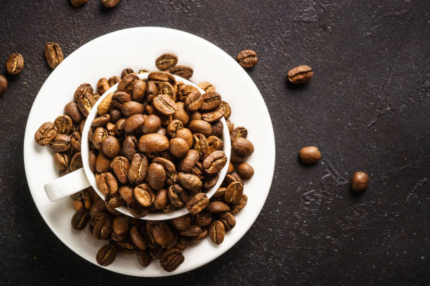 roasted coffee beans in white cup at dark table. - sack bag bean burlap imagens e fotografias de stock