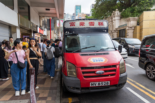 Hong Kong - August 25, 2023 : People buying ice cream at the Mobile Softee ice cream van in Tsim Sha Tsui, Kowloon, Hong Kong.