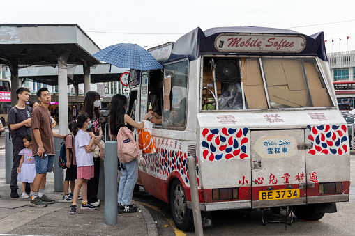 Hong Kong - August 25, 2023 : People buying ice cream at the Mobile Softee ice cream van in Tsim Sha Tsui, Kowloon, Hong Kong.