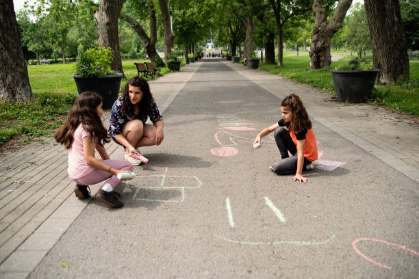 istock Mother of middle-eastern ethnicity playing with two active daughters in park. 1638162098