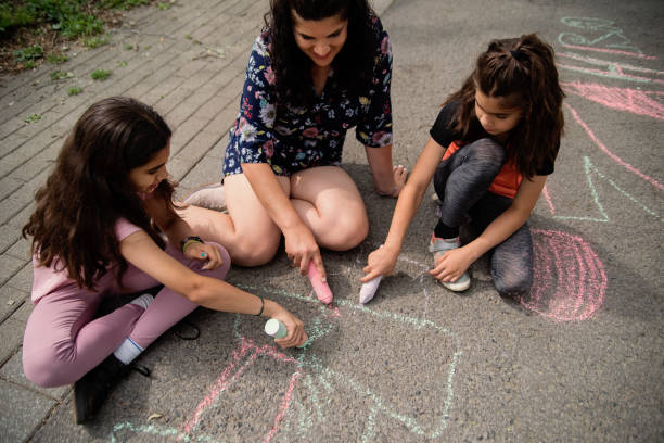 istock Mother of middle-eastern ethnicity playing with two active daughters in park. 1638162328