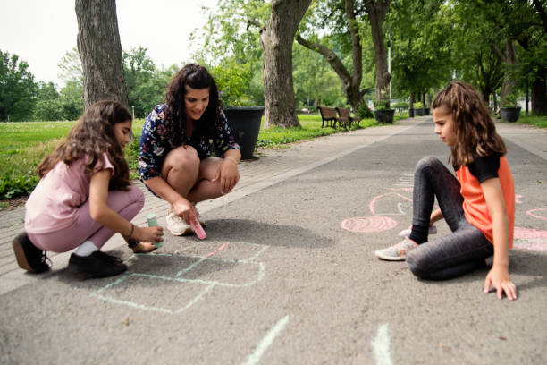 istock Mother of middle-eastern ethnicity playing with two active daughters in park. 1638163393