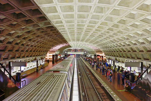Train and commuters in a Washington DC Metro Station.
