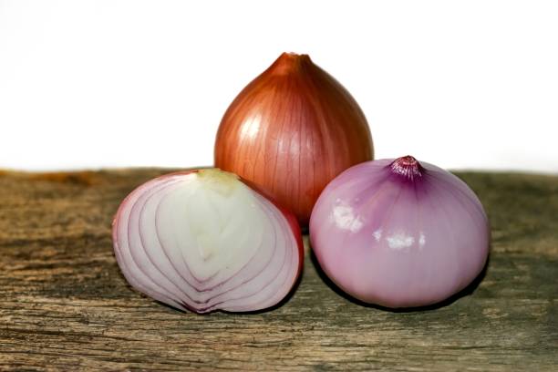 istock Onions sliced half put on old wooden with white background isolate photo. 1638211656