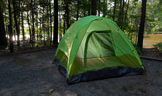 istock Sunlight reflecting off a lake behind a tent 1638231003