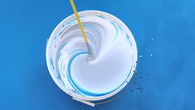 Paint whisk on drill as mixer for mixing paints.